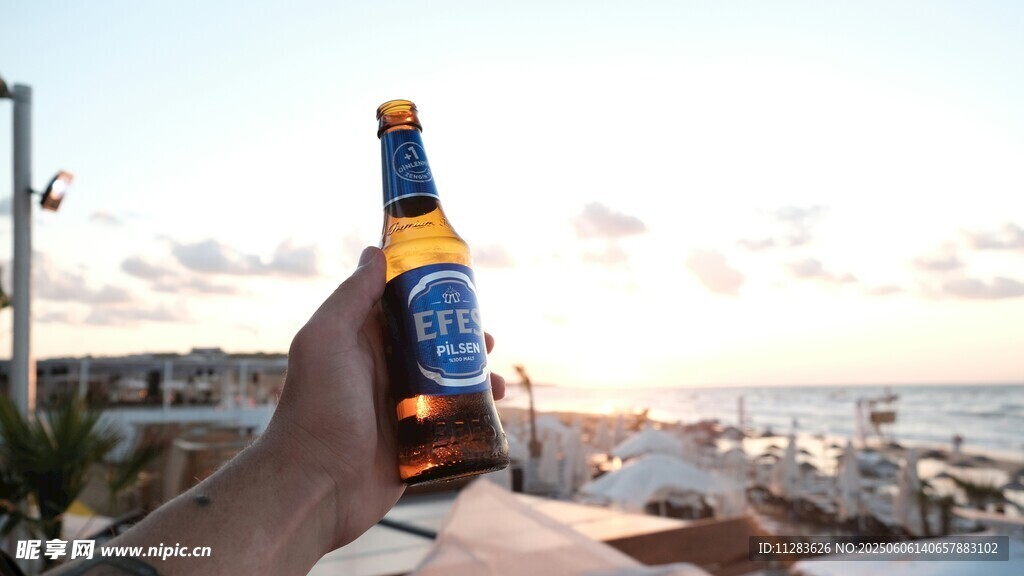 夕陽下手持啤酒愜意一刻