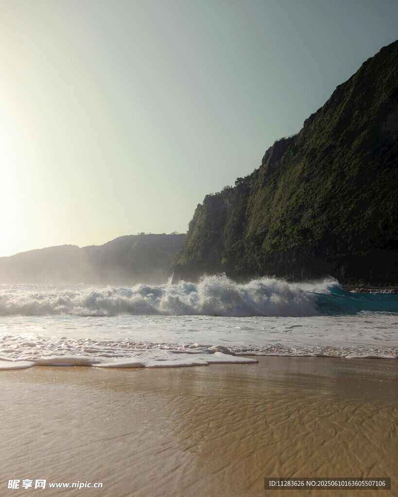 陽光沙灘海浪與陡峭山崖