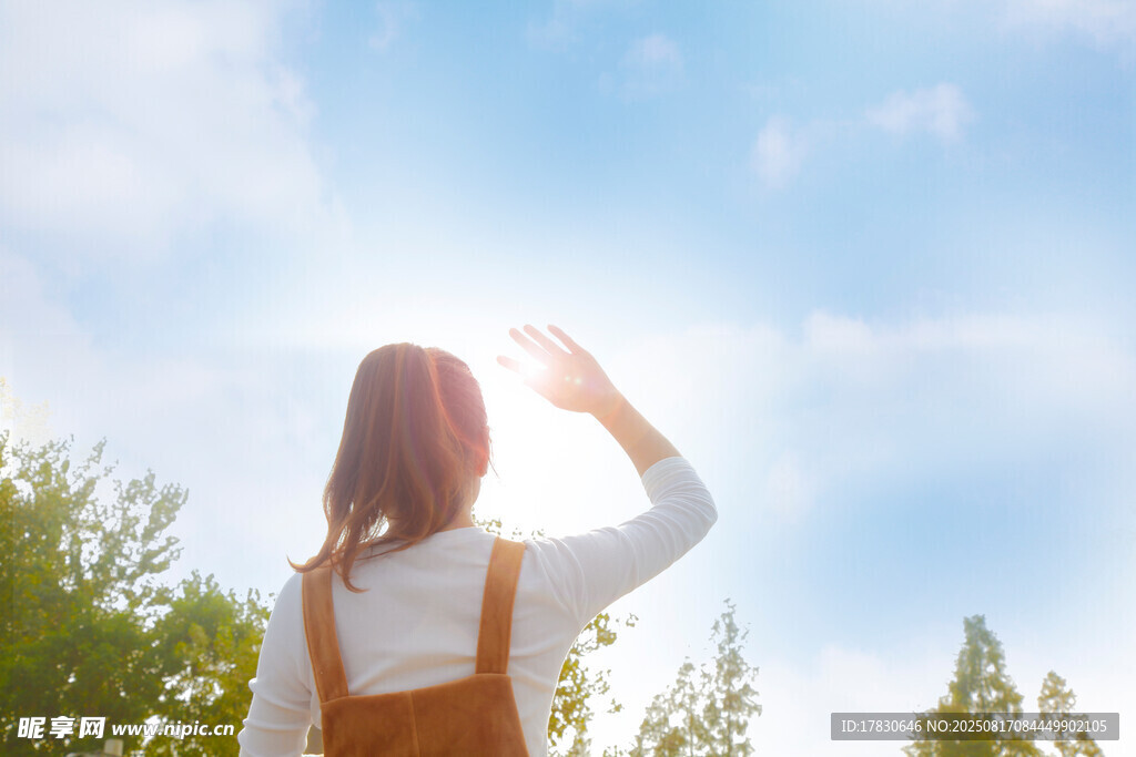 女孩逆光而立望向天空