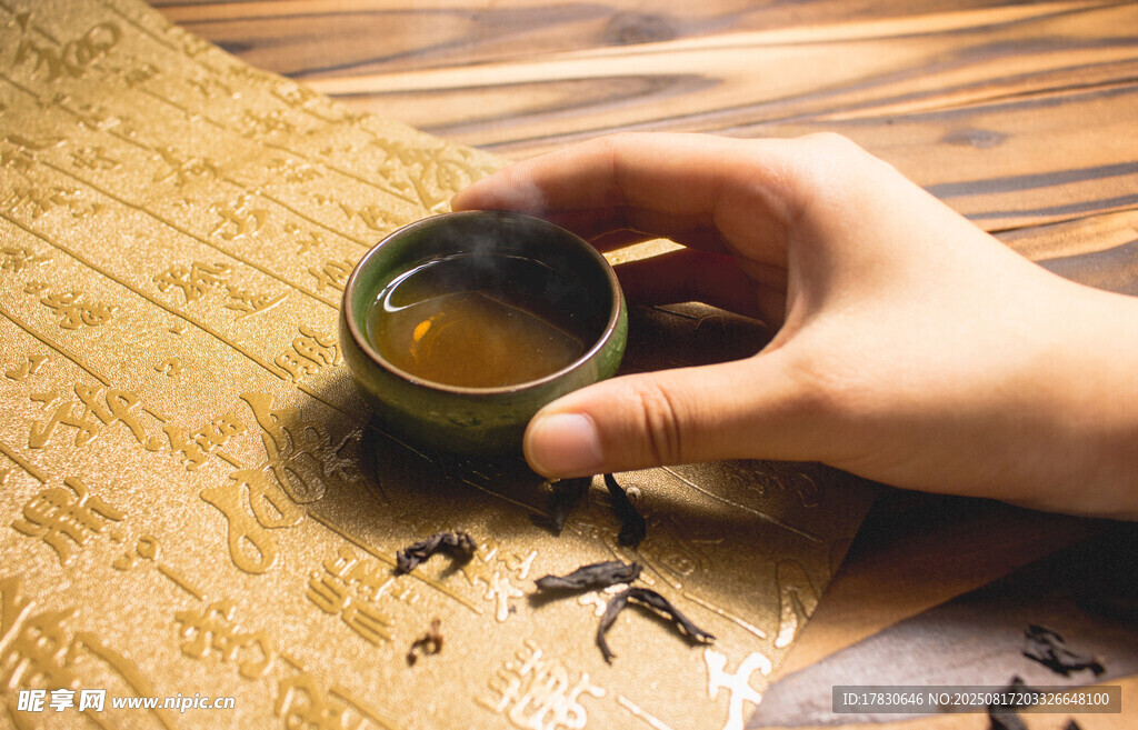 手捧茶盞于古樸書卷上