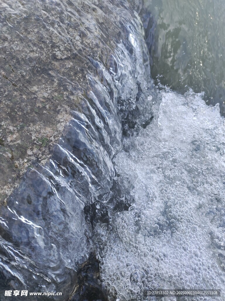 水流沖擊巖石激起浪花
