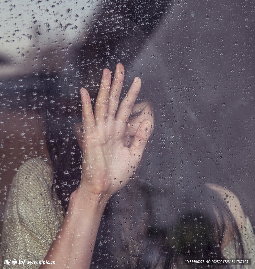 雨中手貼玻璃的孤獨(dú)身影