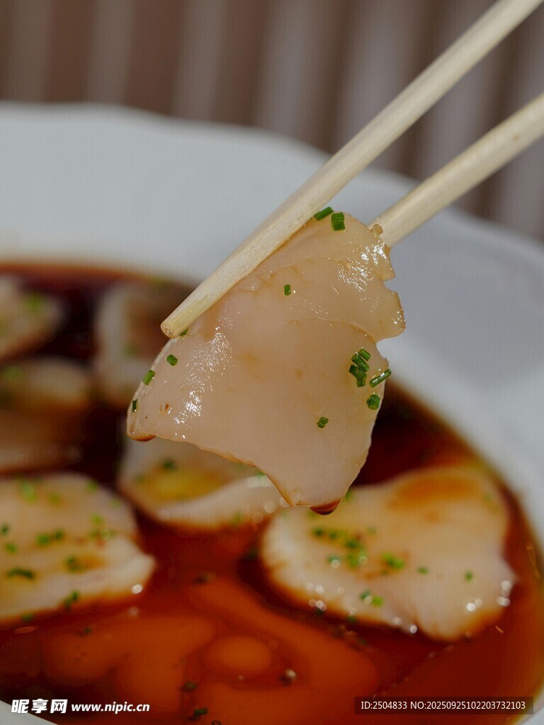 筷子夾起的鮮嫩扇貝肉