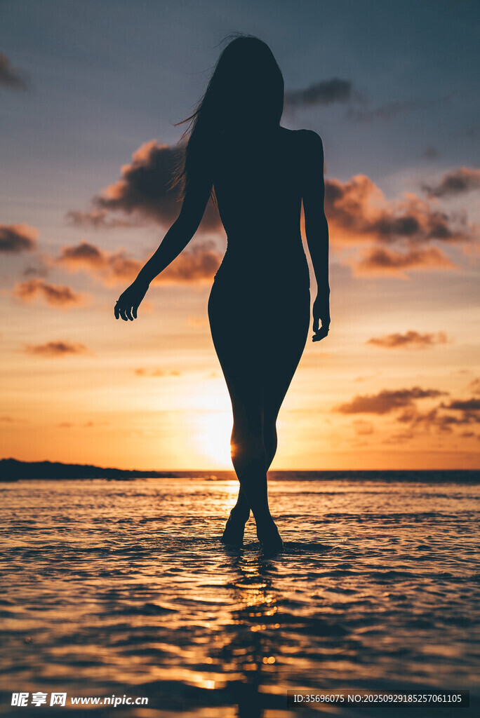 夕陽(yáng)下海邊漫步的女子