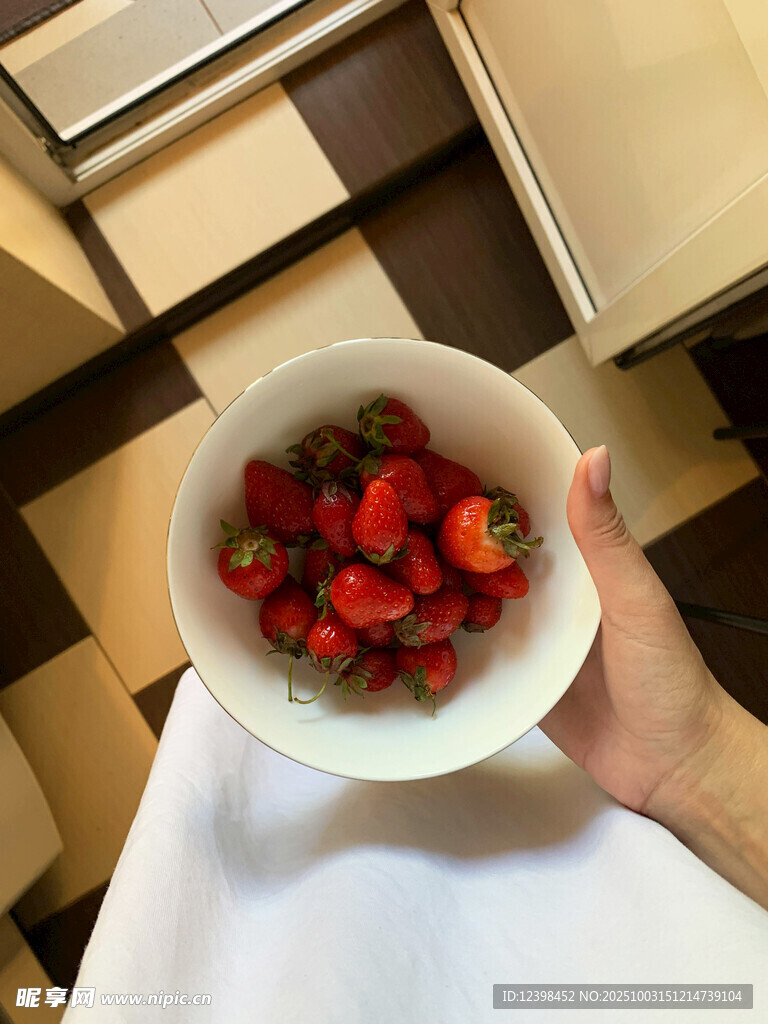 手捧一碗新鮮草莓