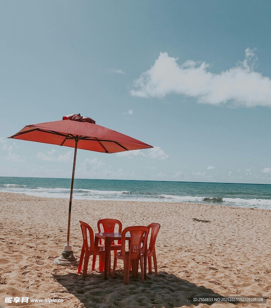 沙灘上的紅傘桌椅與海景