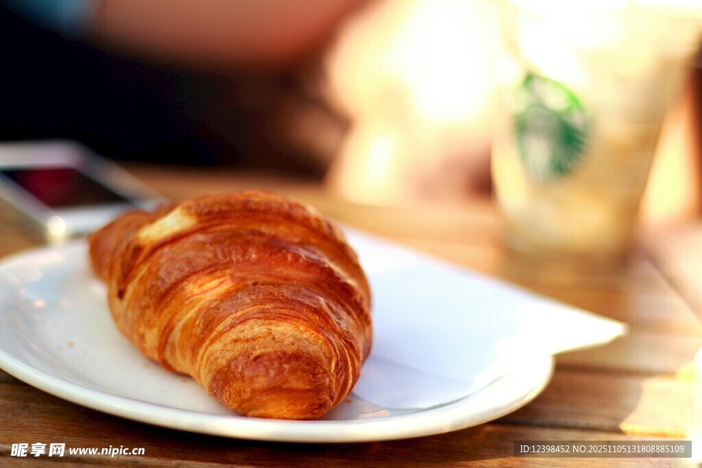 美味牛角面包置于白盤上