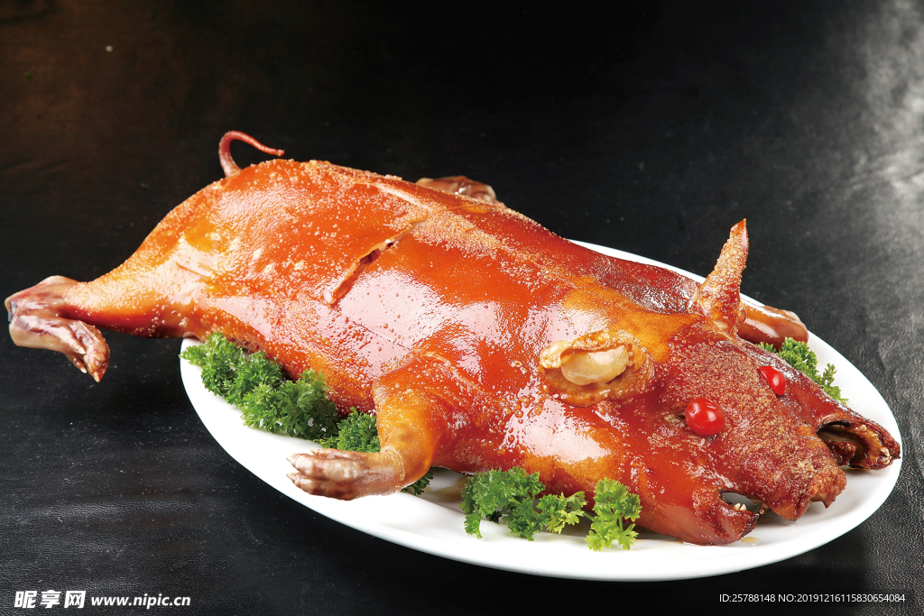 Whole roasted suckling pig on a bed of lettuce