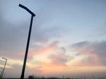 冬日早晨路灯朝霞与明月晴朗天空