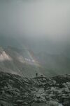 孤独旅行者登山中彩虹雪山风景