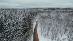 航拍雪林中道路