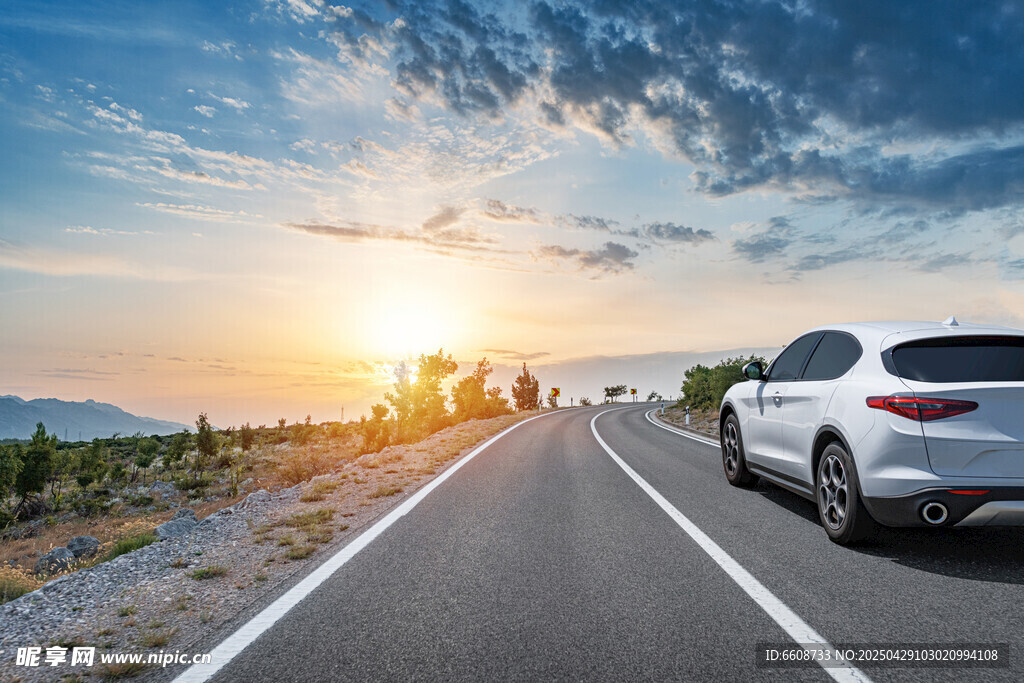 夕阳下公路上的白色汽车