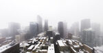 雪后雾中城市高楼景观