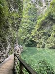 山间木栈道旁的碧绿湖水