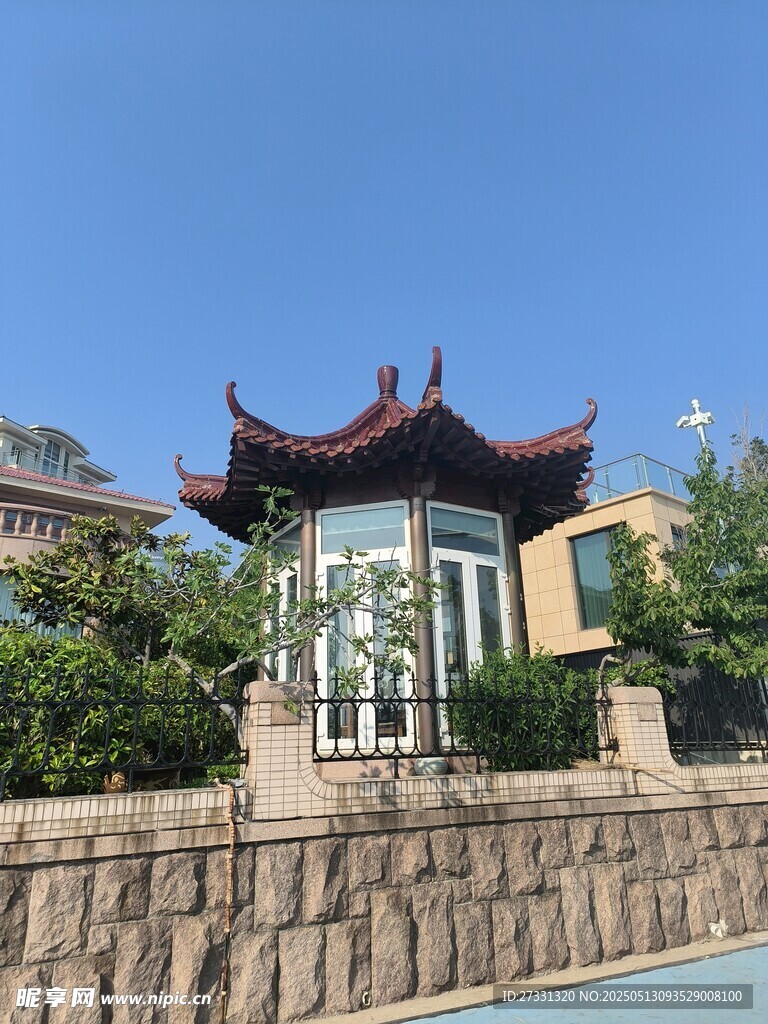中式古亭立于绿植环绕处