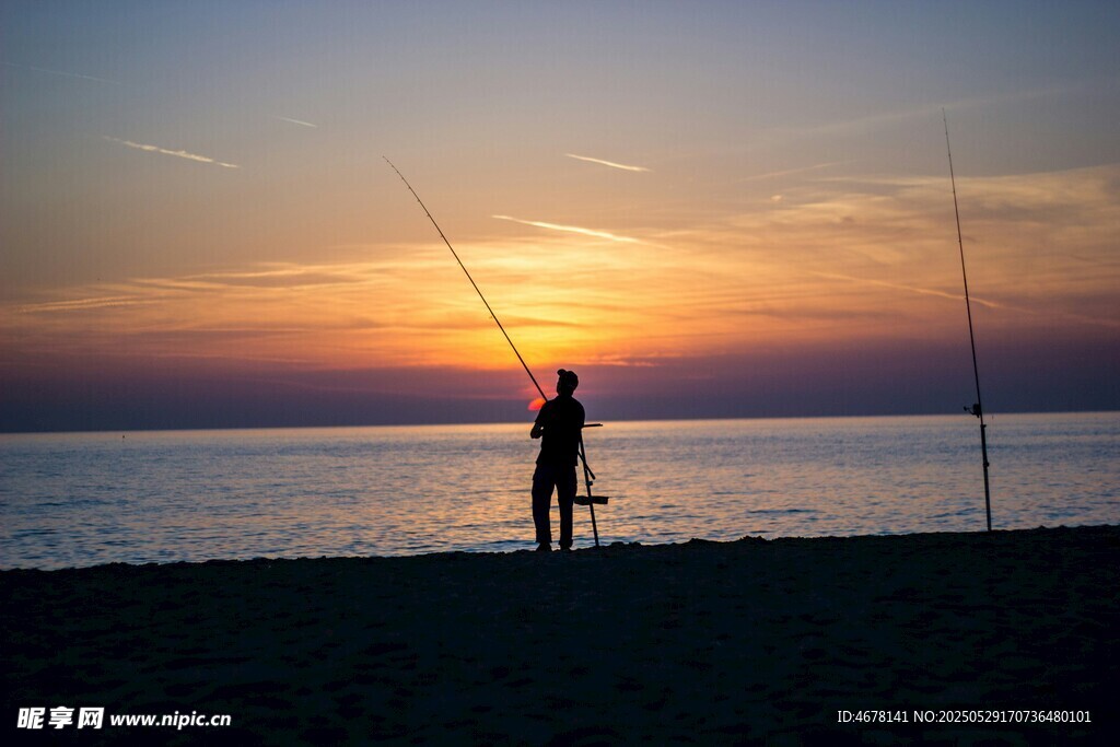 夕阳下的海边垂钓者