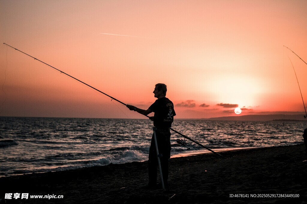 夕阳下海边垂钓者剪影