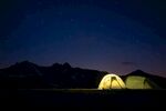 山间夜露营帐篷微光闪烁