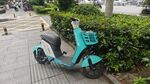 时尚蓝绿色电动摩托车停放