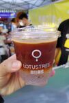 手持一杯LOTUSTREE饮品