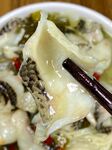 筷子夹起的鲜嫩酸菜鱼