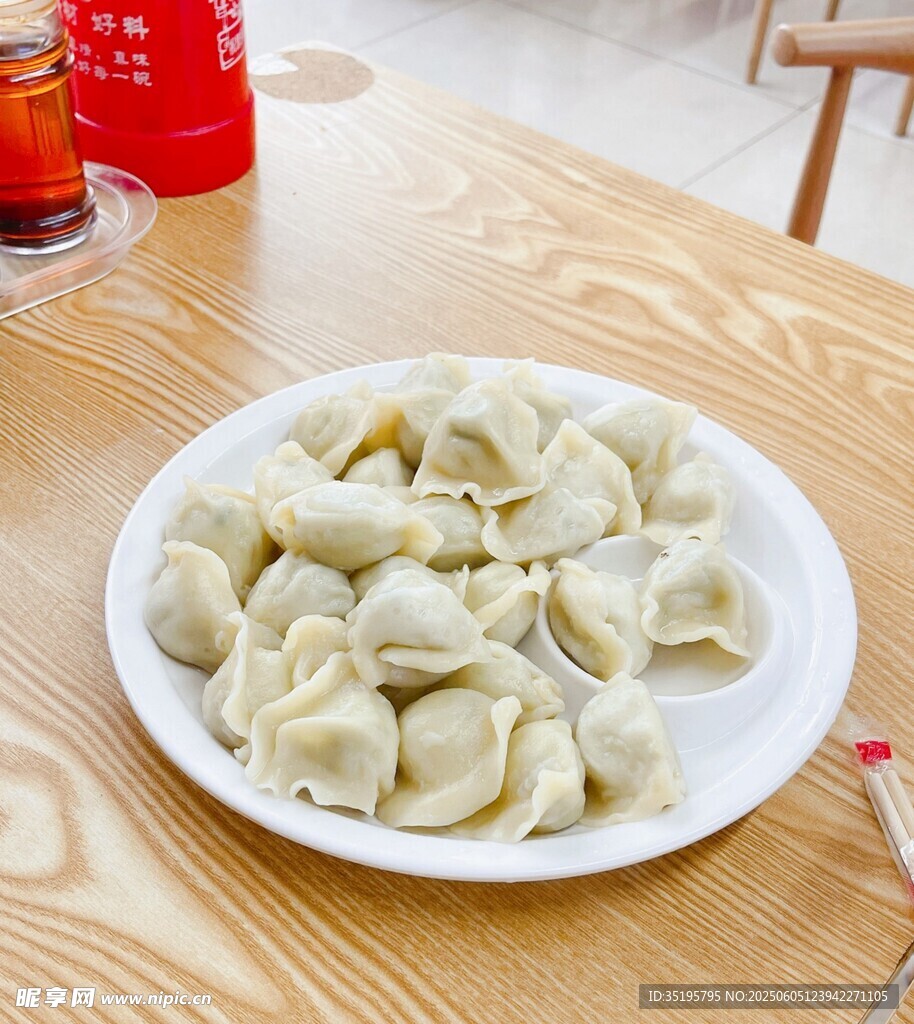 一盘美味饺子摆于木桌