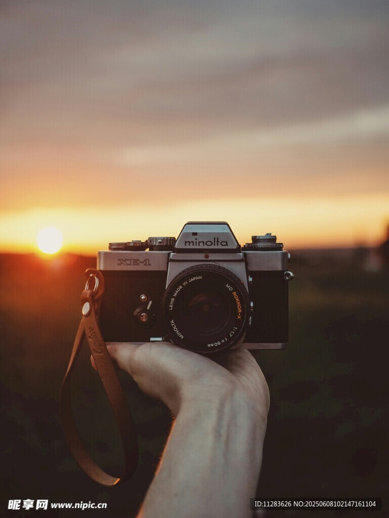夕阳下手持复古相机