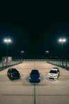 夜晚停车场中的三辆汽车