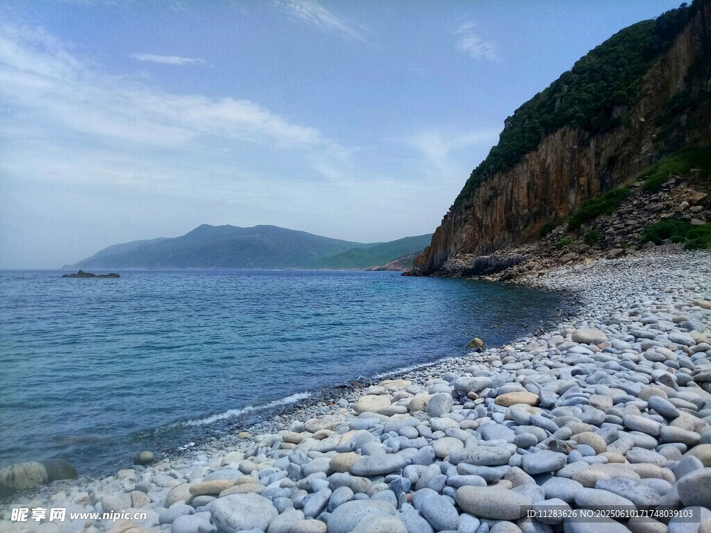 海边碎石滩与远处山峦