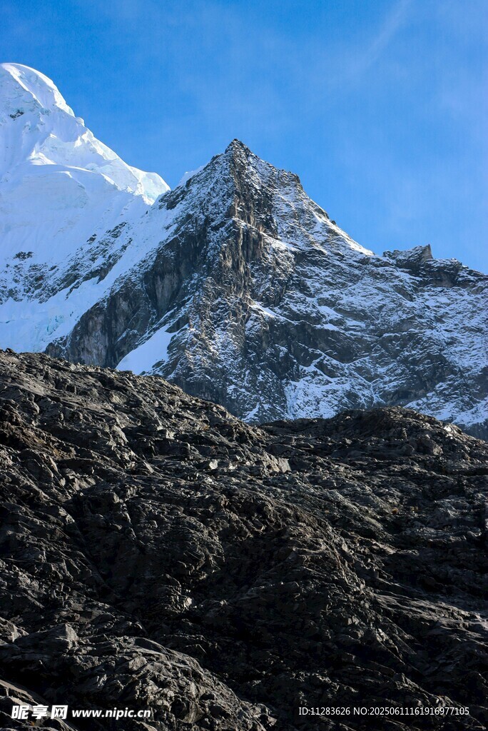 巍峨雪山下的嶙峋岩石