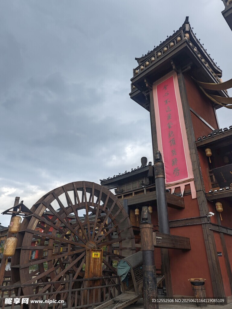 古风水车旁的中式塔楼