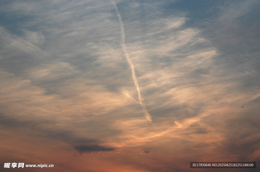 夕阳下天空中的飞机尾迹
