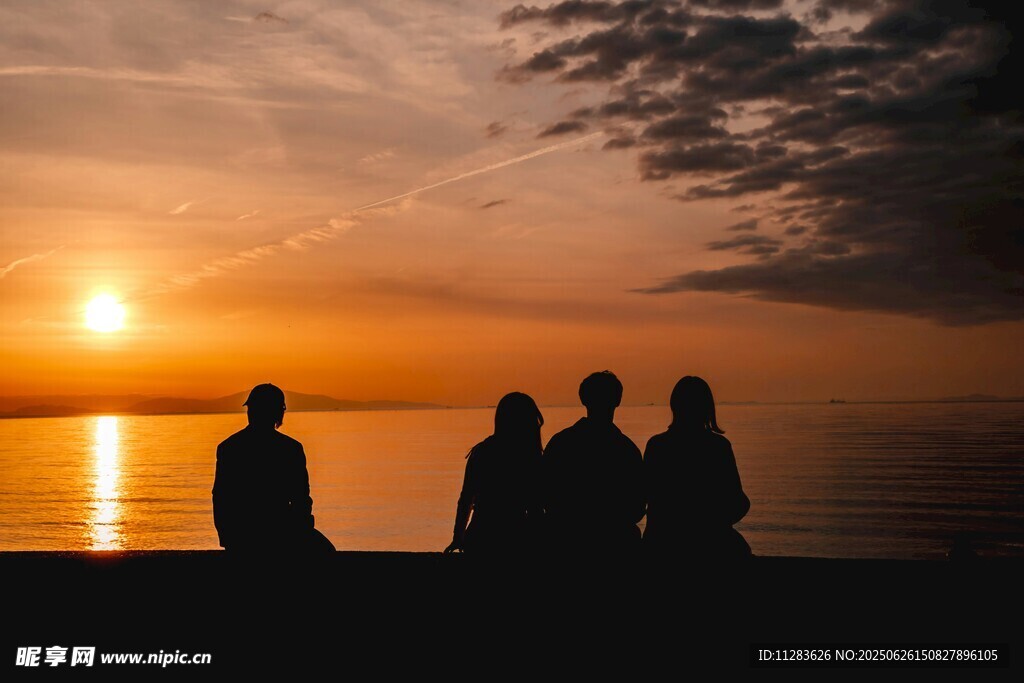 夕阳下的四人海边剪影