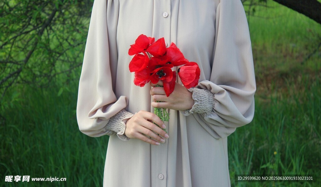 女子手持鲜艳红花朵