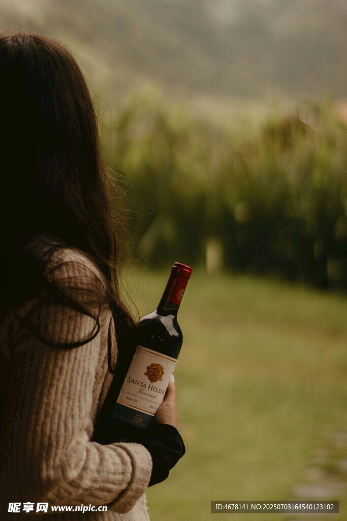 女子手持酒瓶眺望远方