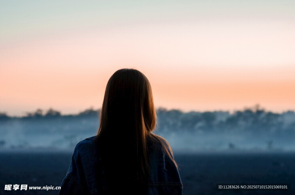 女子背对赏黄昏美景