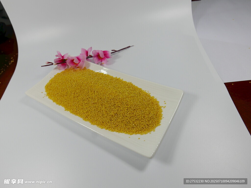 金黄小米摆于盘旁有小花
