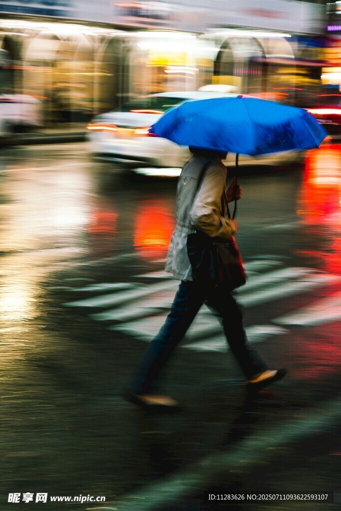 雨中行人撑蓝伞过马路
