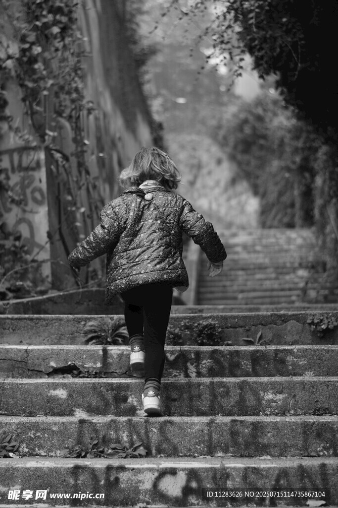 小孩独自走在石阶小路上