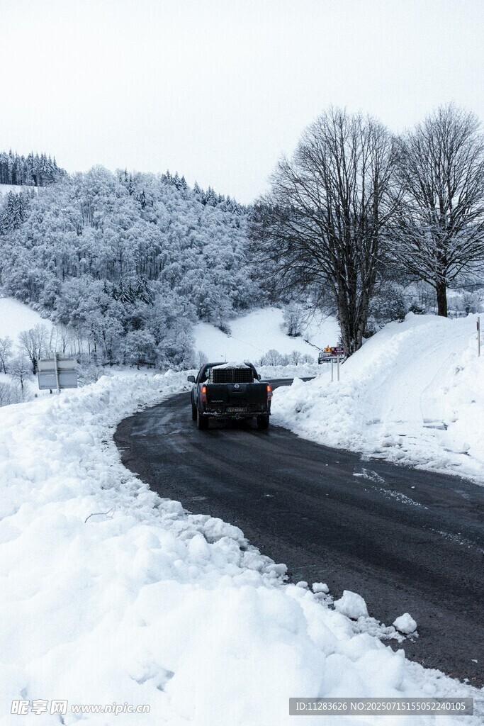 雪天公路上行驶的黑色汽车