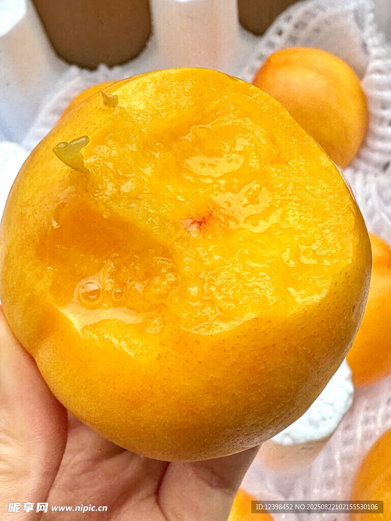 手捧金黄多汁大桃子