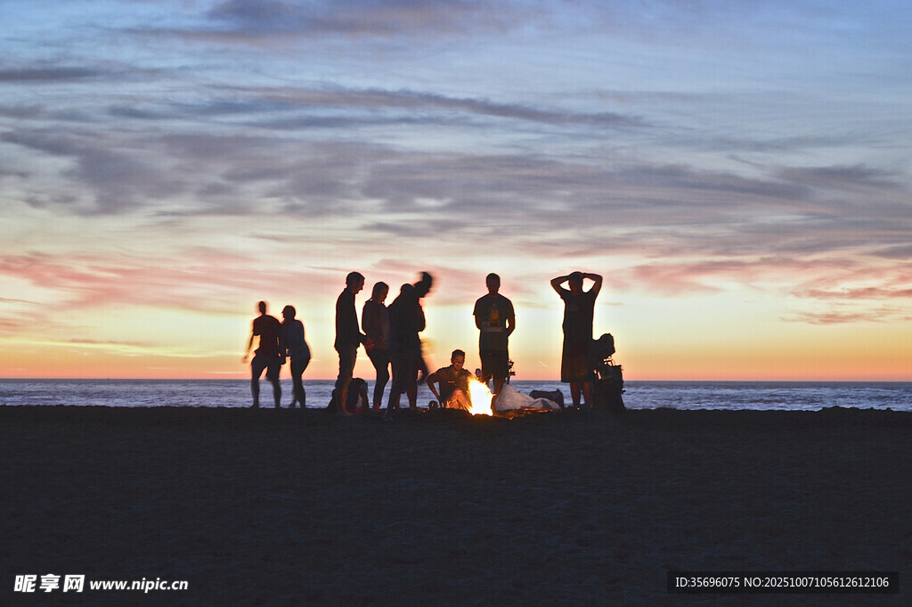 夕阳下的篝火旁人群聚会