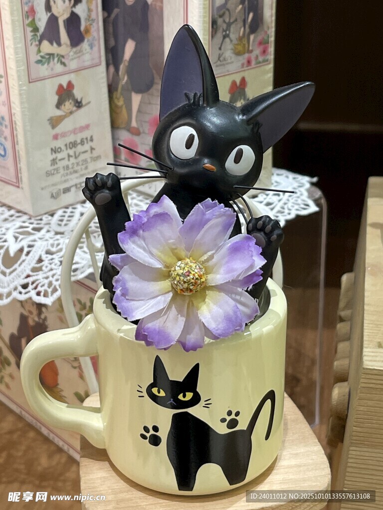 黑猫摆件配紫花于杯上
