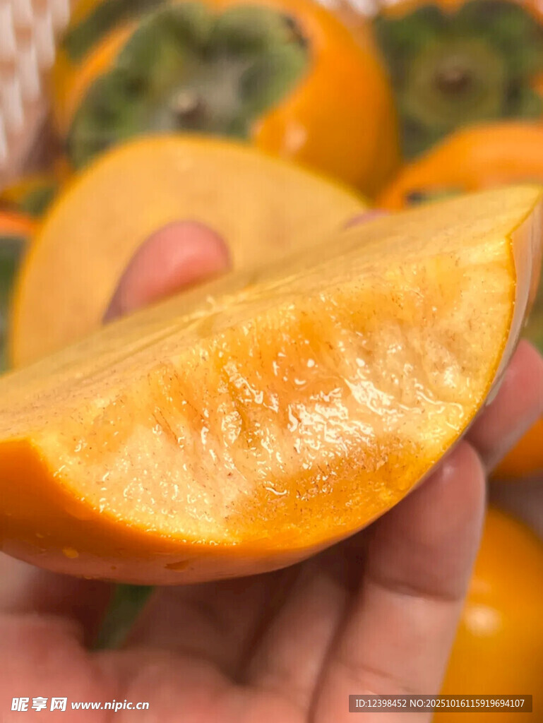 手捧切开的新鲜甜柿子