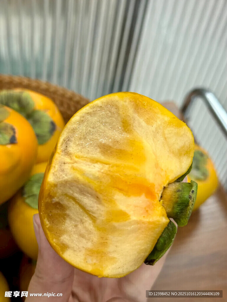 掰开的黄柿子展示诱人果肉