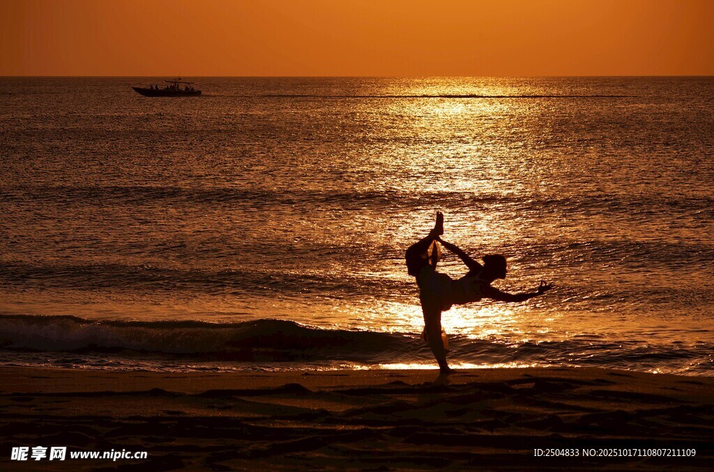 夕阳下海边瑜伽者剪影