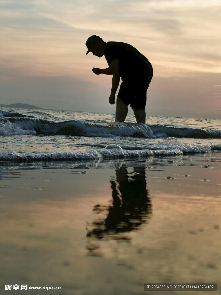 海边黄昏下的孤独拾贝者