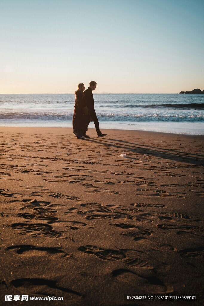 夕阳下海边的浪漫情侣
