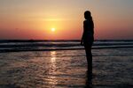 夕阳下海边的孤独身影