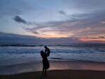 海边情侣夕阳下浪漫剪影